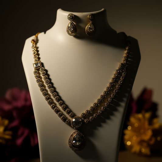 Jewelry set with necklace and earrings on a mannequin bust against a white background